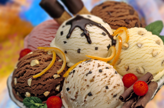 A composition of various flavours ice cream balls decorated with red fruits,chocolate curls and mint