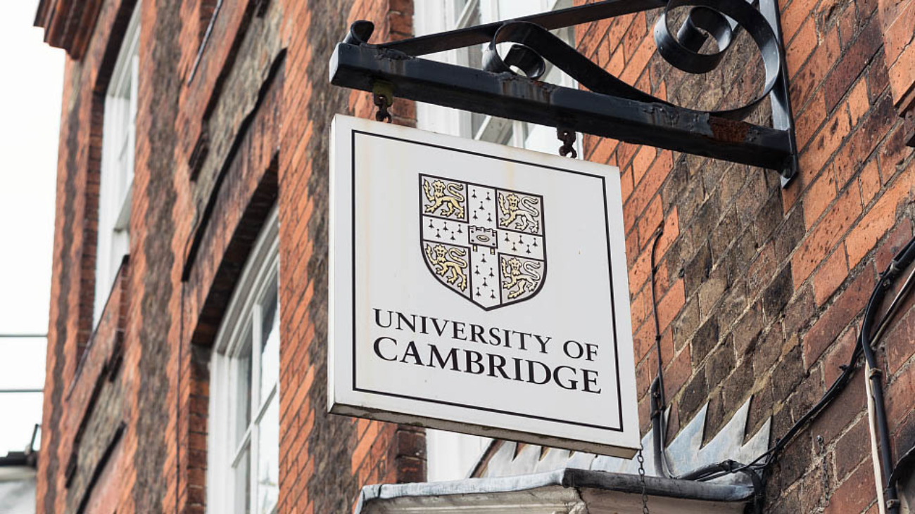 Cambridge, UK - A University of Cambridge  sign above the entrance to a Victorian building in the centre of the traditional English university city.