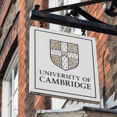 Cambridge, UK - A University of Cambridge  sign above the entrance to a Victorian building in the centre of the traditional English university city.