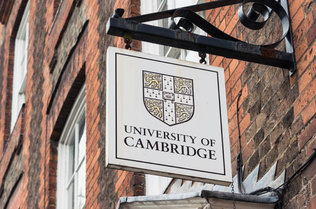 Cambridge, UK - A University of Cambridge  sign above the entrance to a Victorian building in the centre of the traditional English university city.