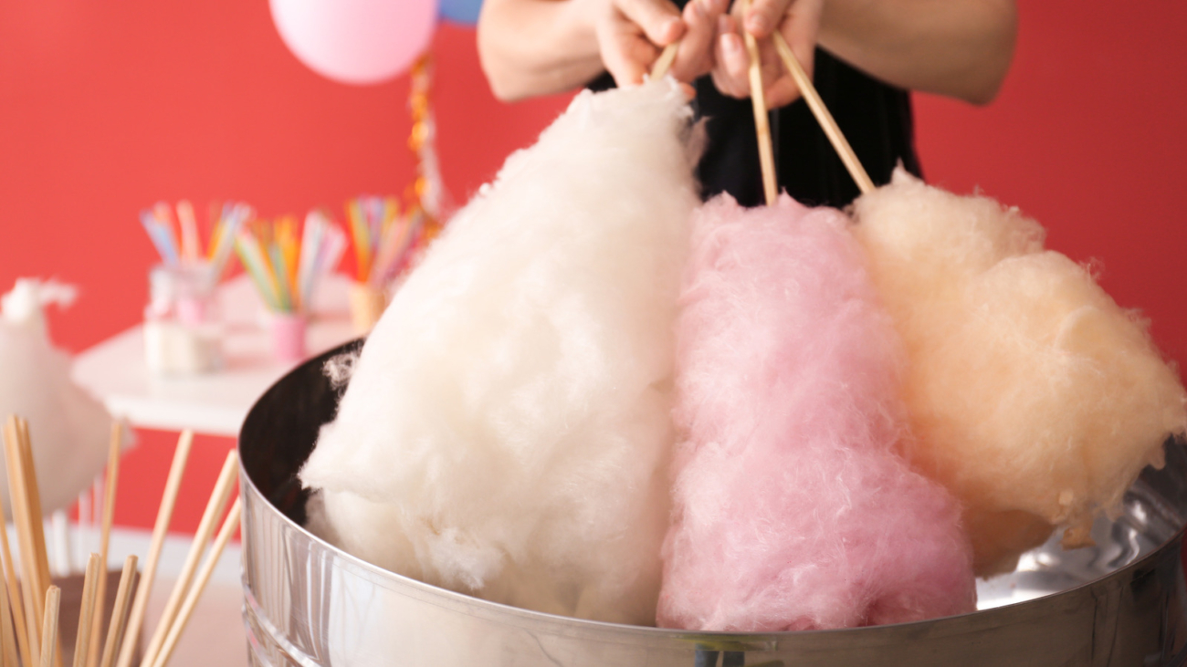 Woman,Making,Cotton,Candy,At,Fair