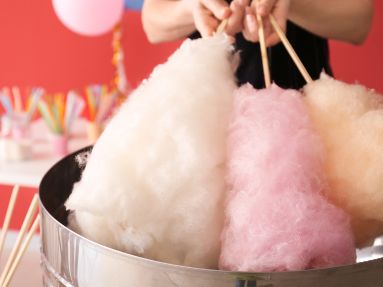 Woman,Making,Cotton,Candy,At,Fair