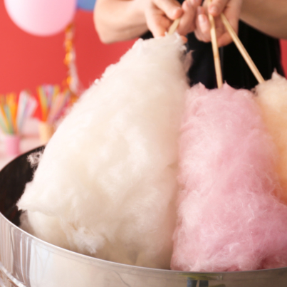 Woman,Making,Cotton,Candy,At,Fair